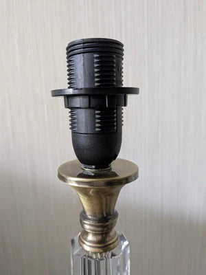 Black and gold bottle stopper on a reflective surface with a neutral background